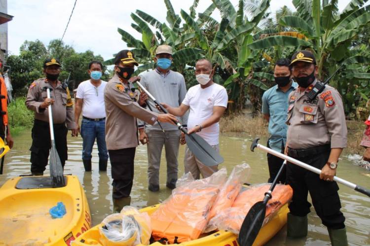 Kapolres Sergai Turunkan Perahu Karet dan Bagikan Sembako untuk Korban Banjir di Sei Rampah